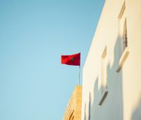 red and white flag on brown concrete building