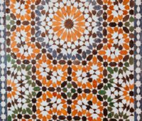 closeup photo of white, orange, and gray area rug
